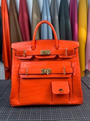Hermès Birkin HAC 40 Multi-Pocket in iconic Feu (Hermès Orange) Niloticus Crocodile with luxurious gold hardware