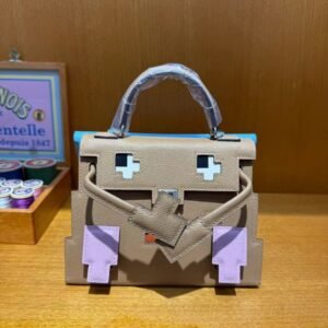 Hermès Kelly Doll Bag in iconic Etoupe Epsom leather with playful patchwork details, a whimsical blend of Hermès heritage and contemporary charm